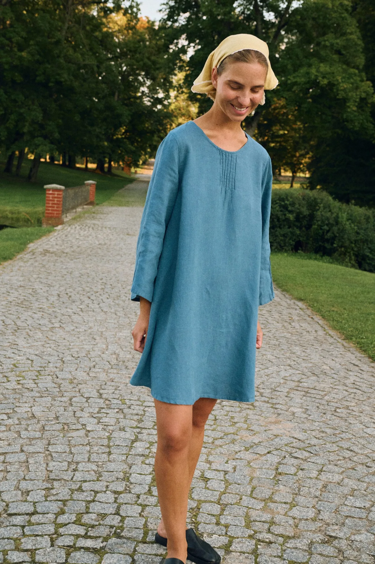 Stellar blue A-line linen mini dress styled with butter yellow bandana as headscarf