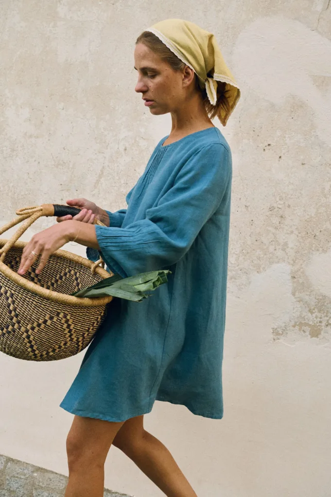 Stellar blue oversized linen mini dress with round neckline and flared sleeves worn with butter yellow bandana