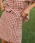 Terracotta gingham linen mini skirt with overlapping front panel and side tie detail