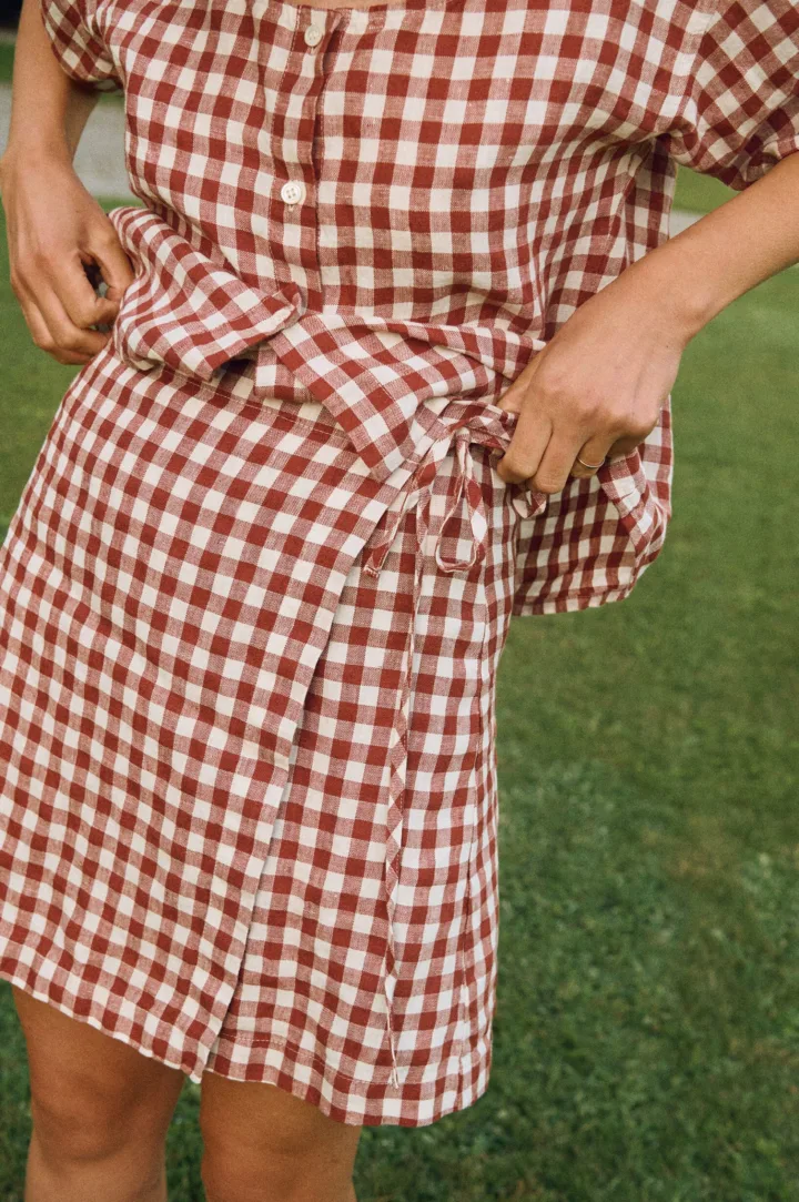 Terracotta gingham linen mini skirt with overlapping front panel and side tie detail