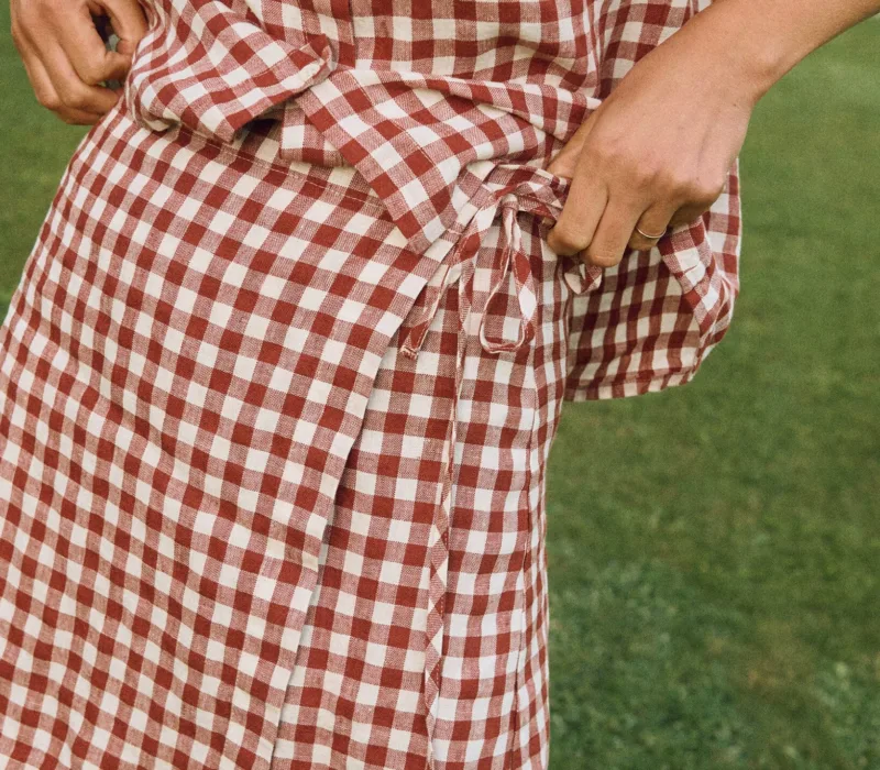 Terracotta gingham linen mini skirt with overlapping front panel and side tie detail