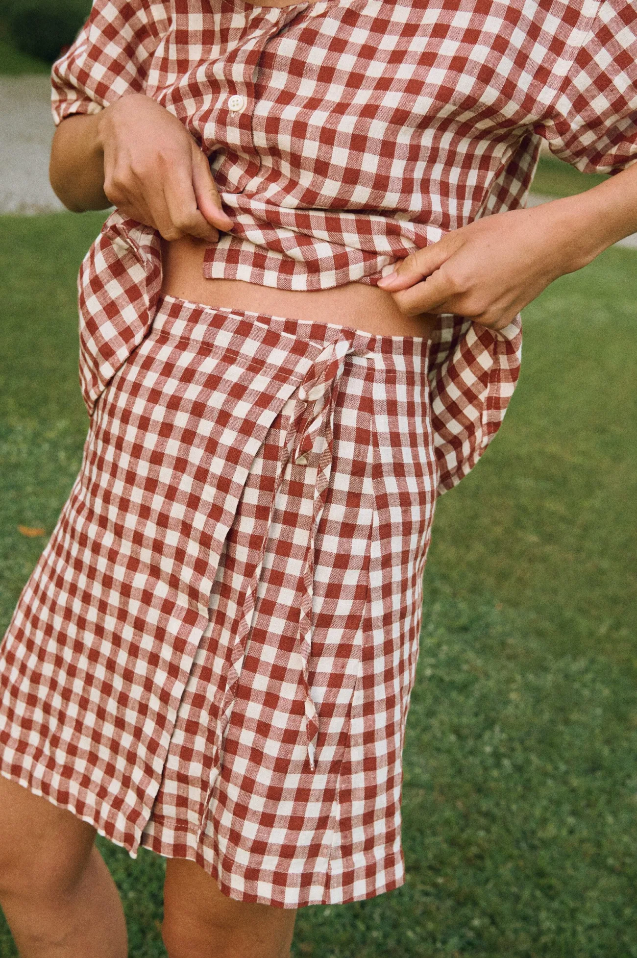 Terracotta gingham linen mini skirt with adjustable waist ties and lightweight texture