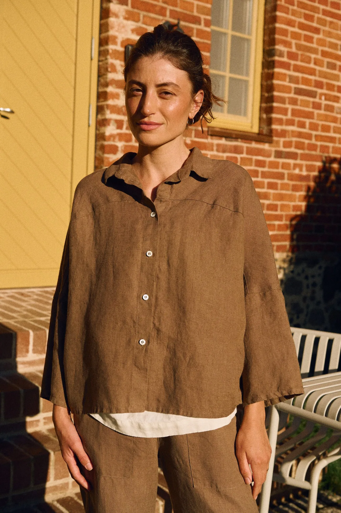 Close-up of cacao linen shirt with shell button fastening and classic collar