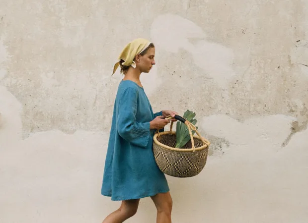Stellar blue linen mini dress styled with butter yellow headscarf, shown in side profile