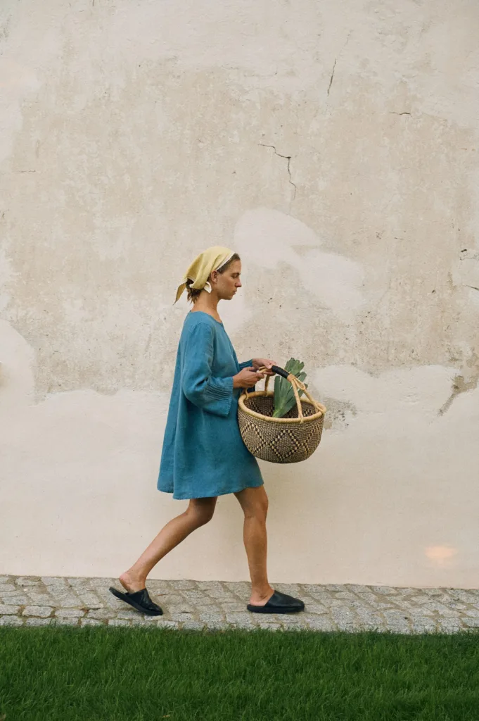 Stellar blue linen mini dress styled with butter yellow headscarf, shown in side profile
