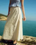 White cotton-blend wrap maxi skirt with tie closure, styled with a dusty blue mini gingham linen smocked peplum top