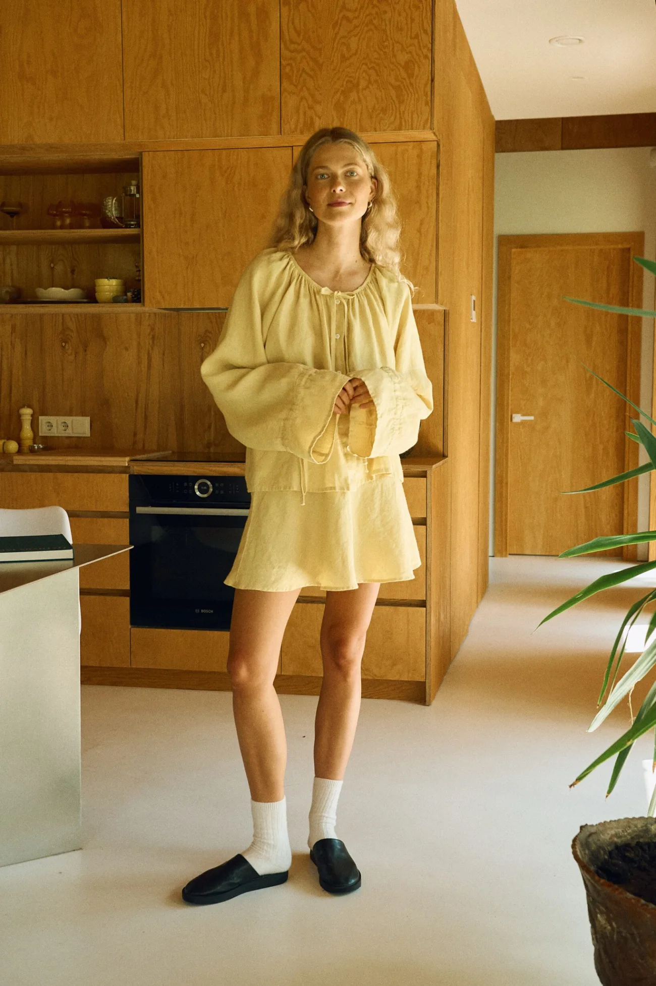 Butter yellow linen blouse with gathered neckline and balloon sleeves, matching linen mini skirt