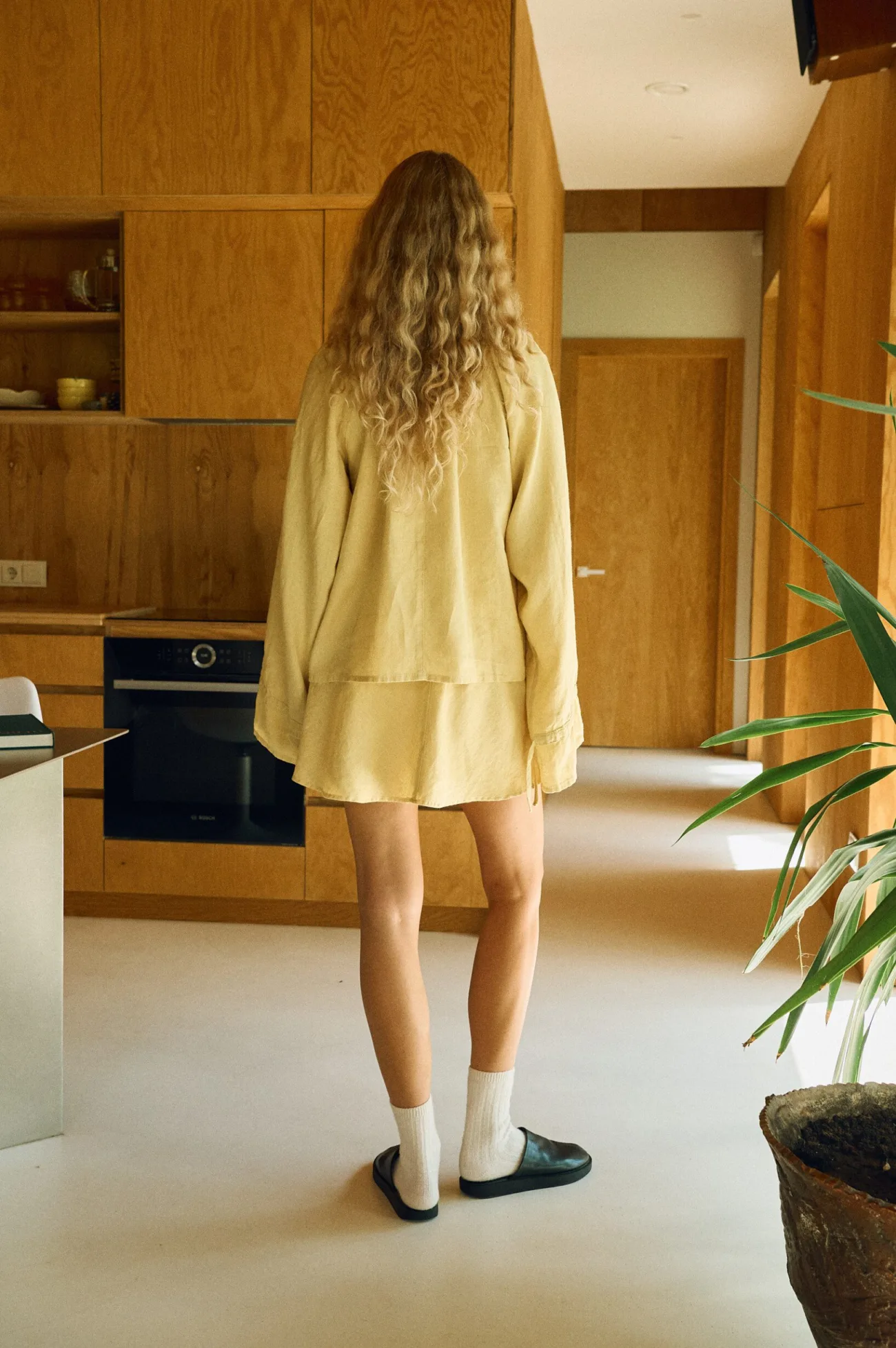 Back view of butter yellow linen peasant blouse with matching mini skirt