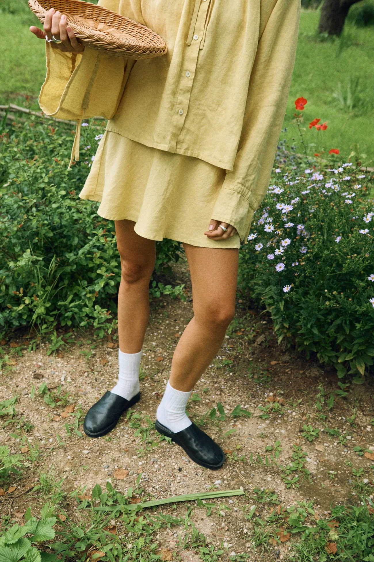 Butter yellow linen blouse and flared mini skirt on model