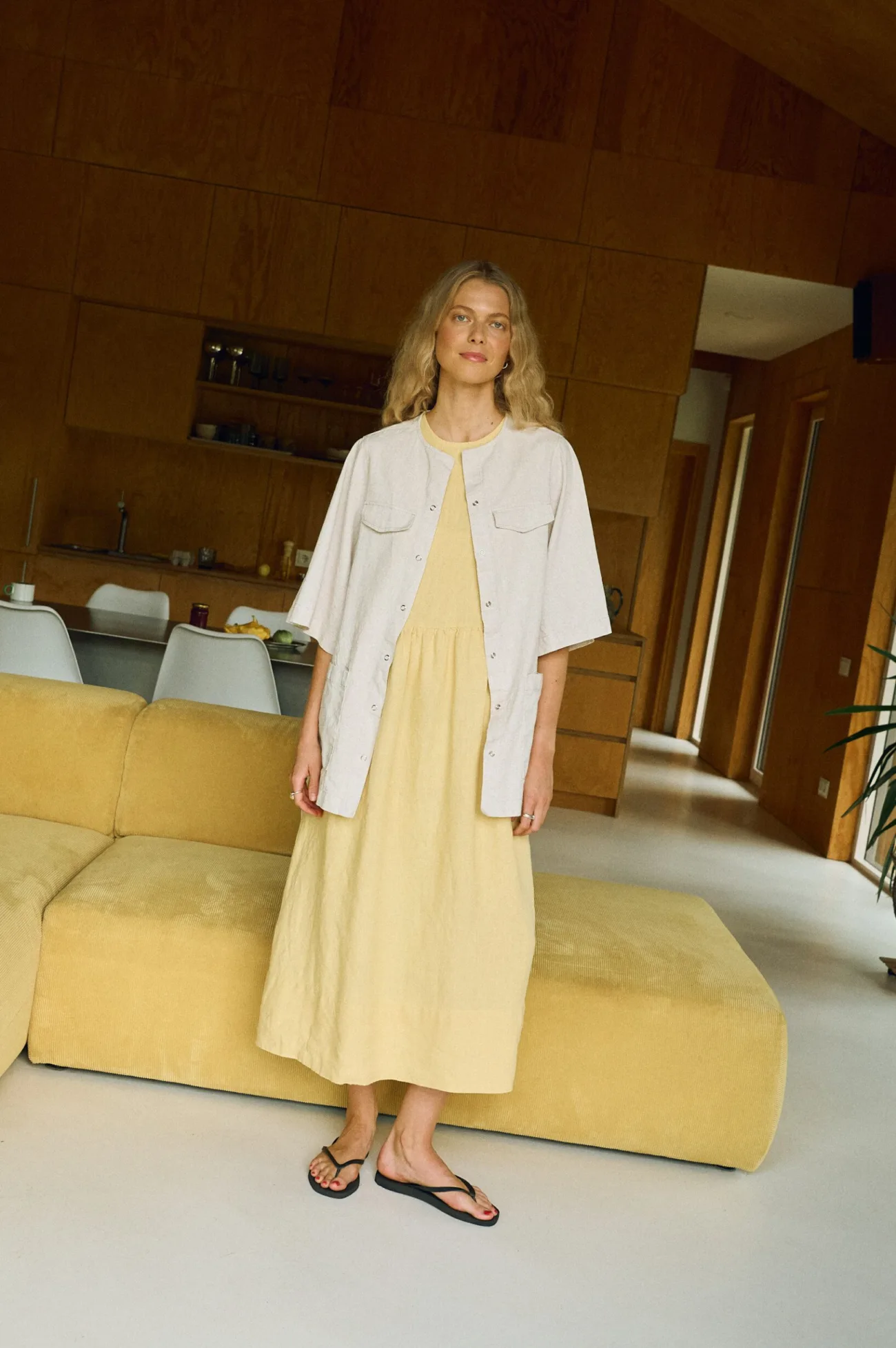 Sleeveless butter yellow linen midi dress styled with a boxy short-sleeve natural linen cotton blend overshirt featuring front patch pockets and snap buttons