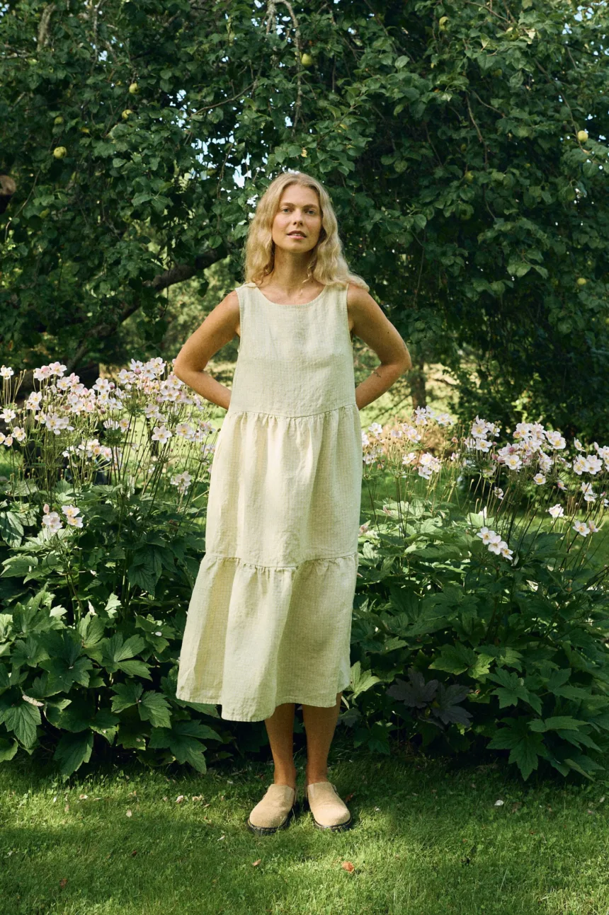 Sleeveless midi dress in apple checks linen featuring a round neckline, relaxed fit, and two gathered tiers