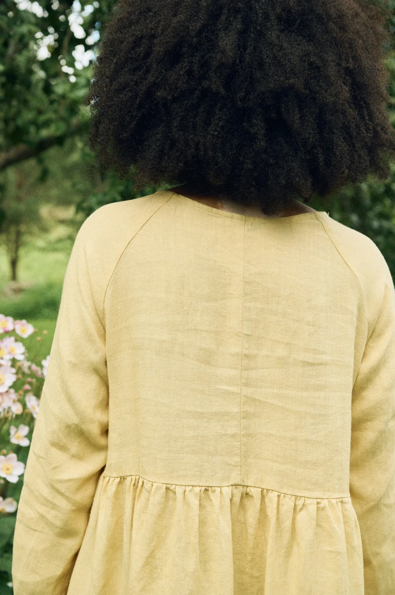 Back detail of the Margo dress, showcasing its raglan sleeves and gathered waist