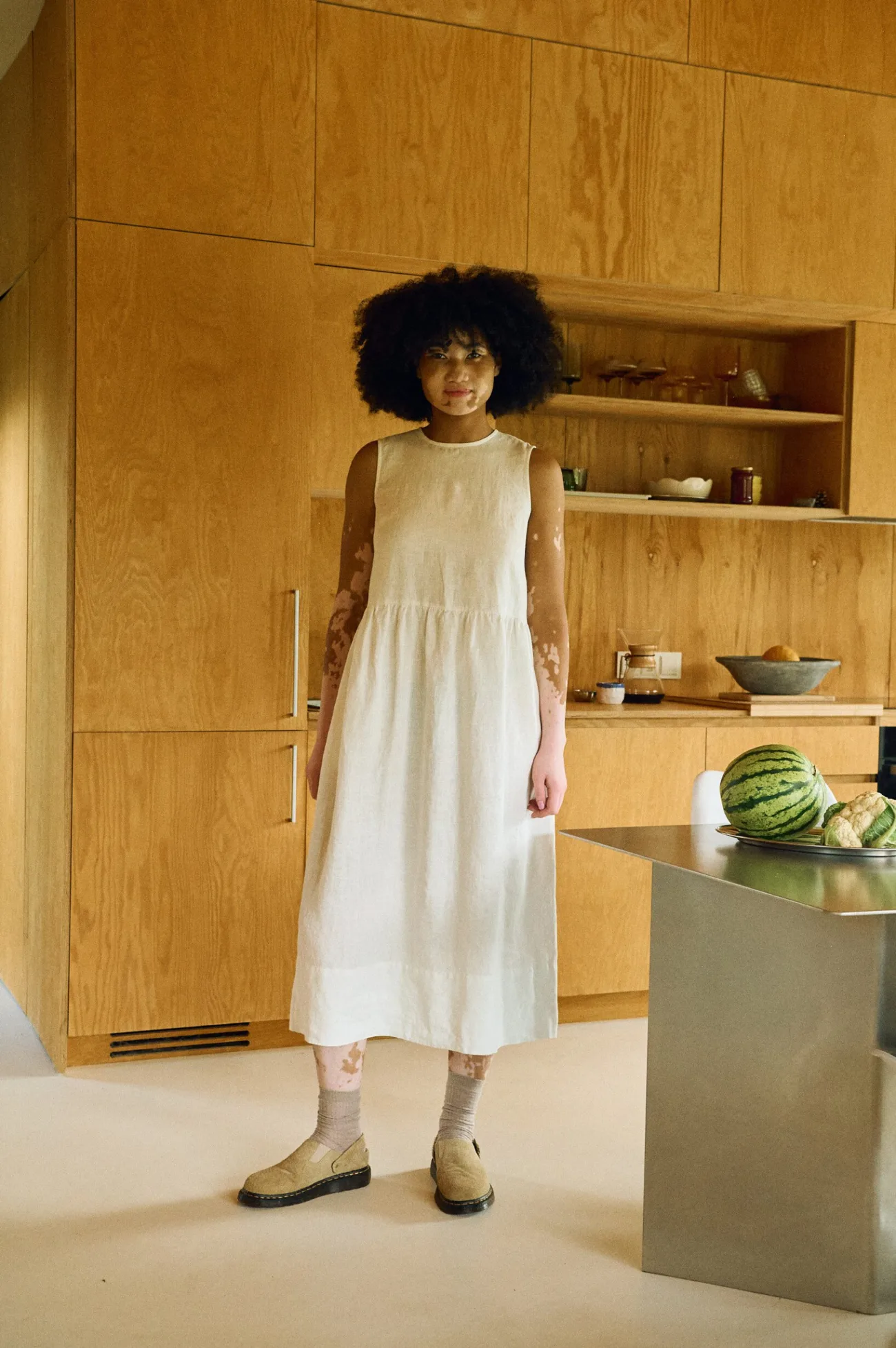 Milky white sleeveless smock linen dress with flowing skirt