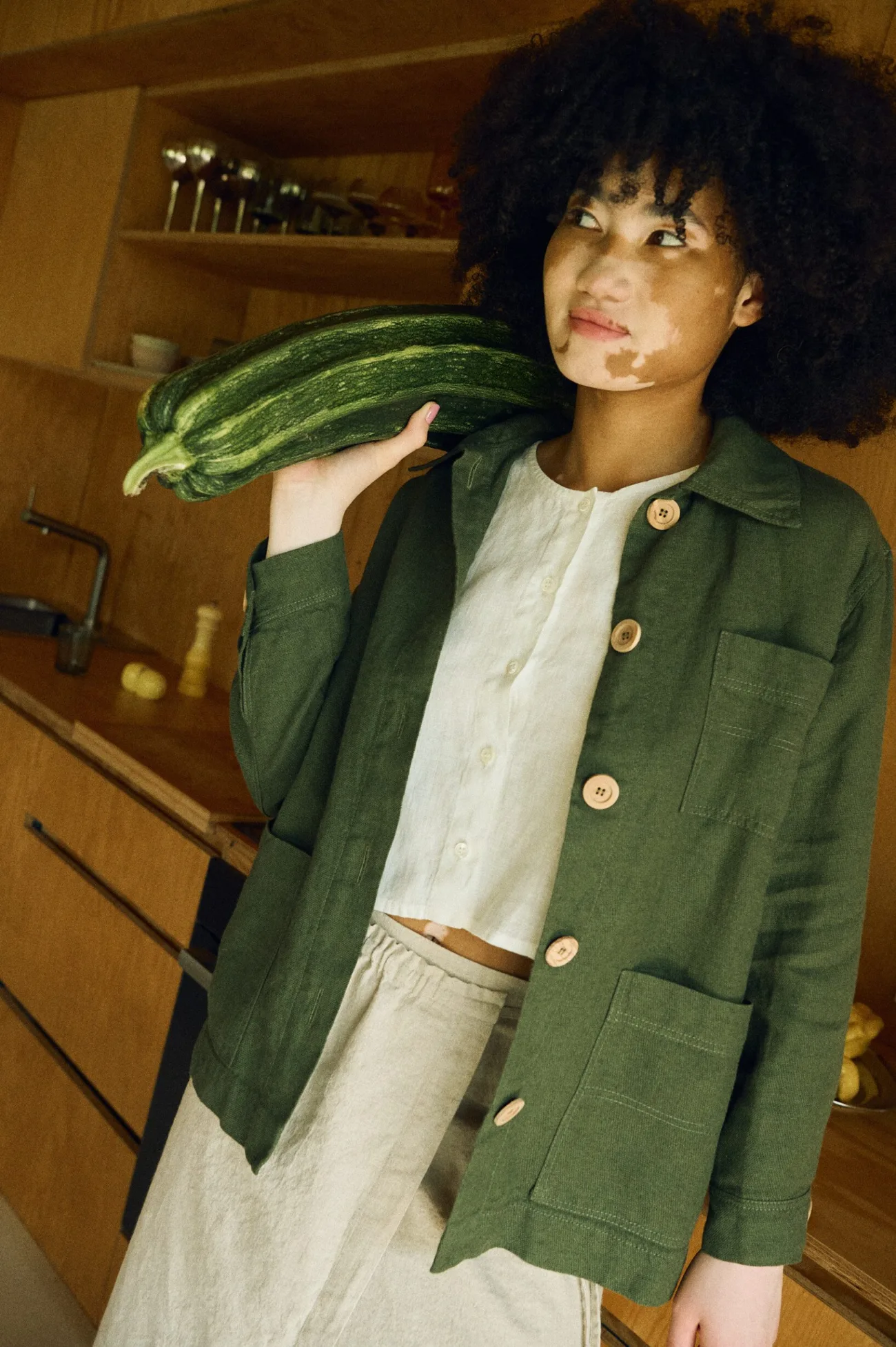 Green linen wool blend jacket with wooden buttons styled over natural linen top and skirt