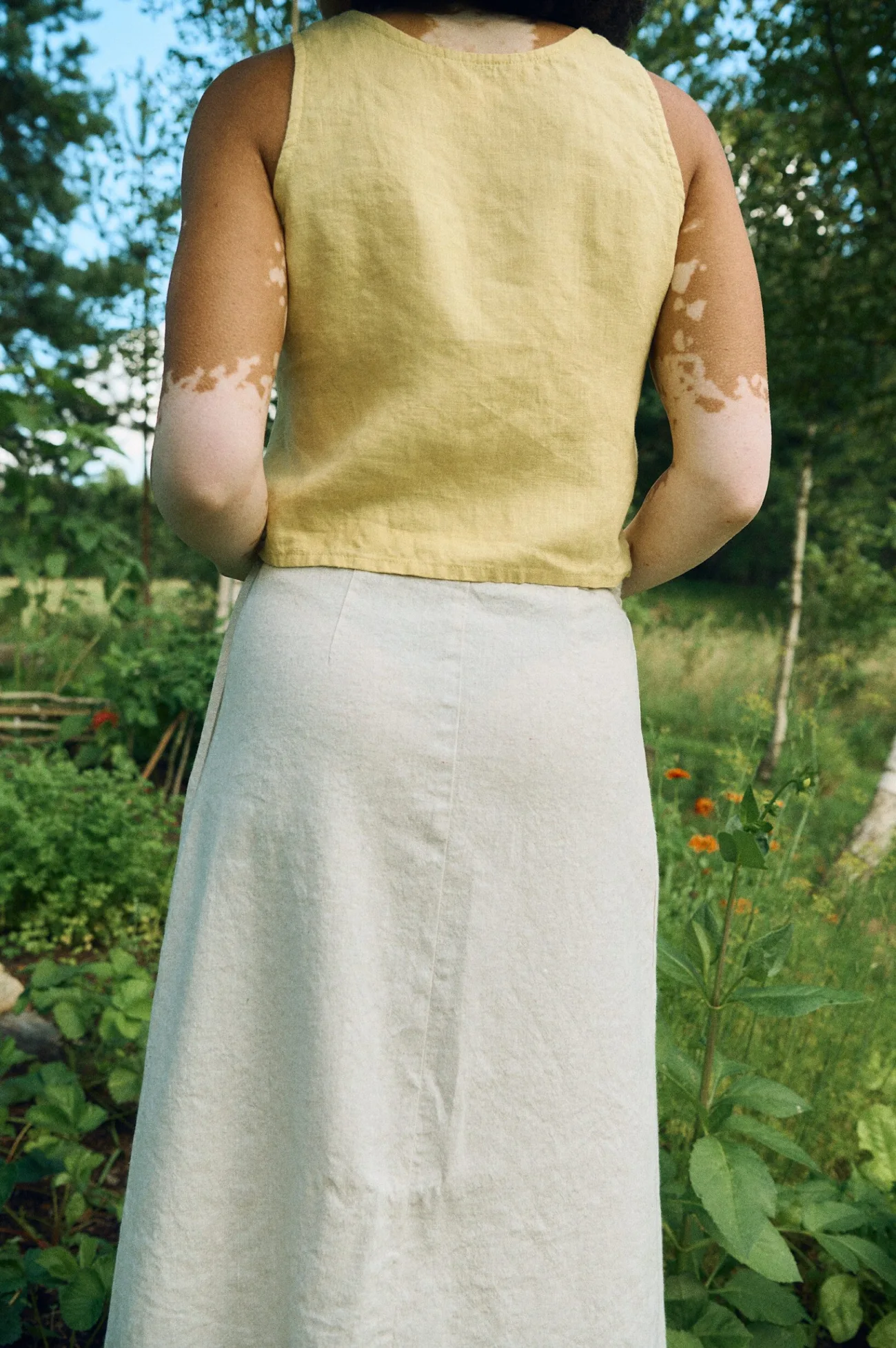 Back silhouette of the boxy linen top and A-line wrap skirt combination