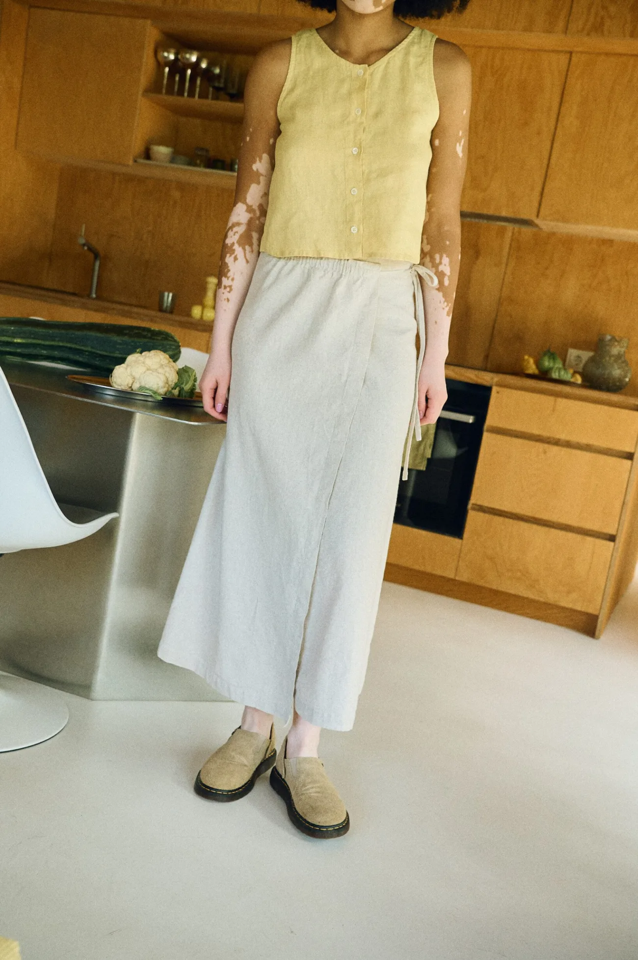 Clean, minimalist outfit with a butter linen cropped top and natural long wrap skirt