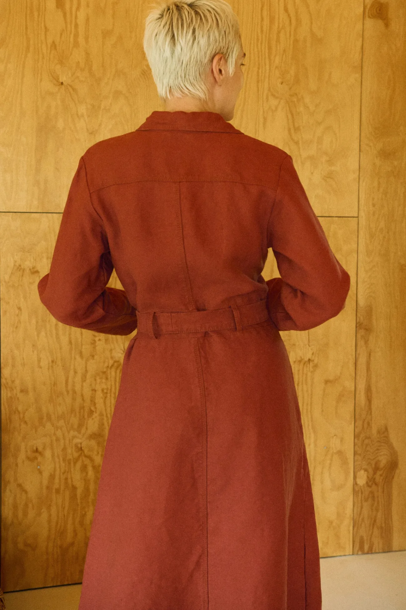 Terracotta heavy linen midi dress back angle, collared bodice, long sleeves, and belt