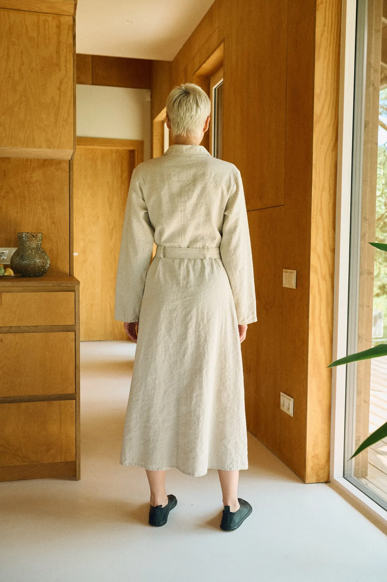 Back view of the natural linen cotton dress, highlighting its clean, minimalist design