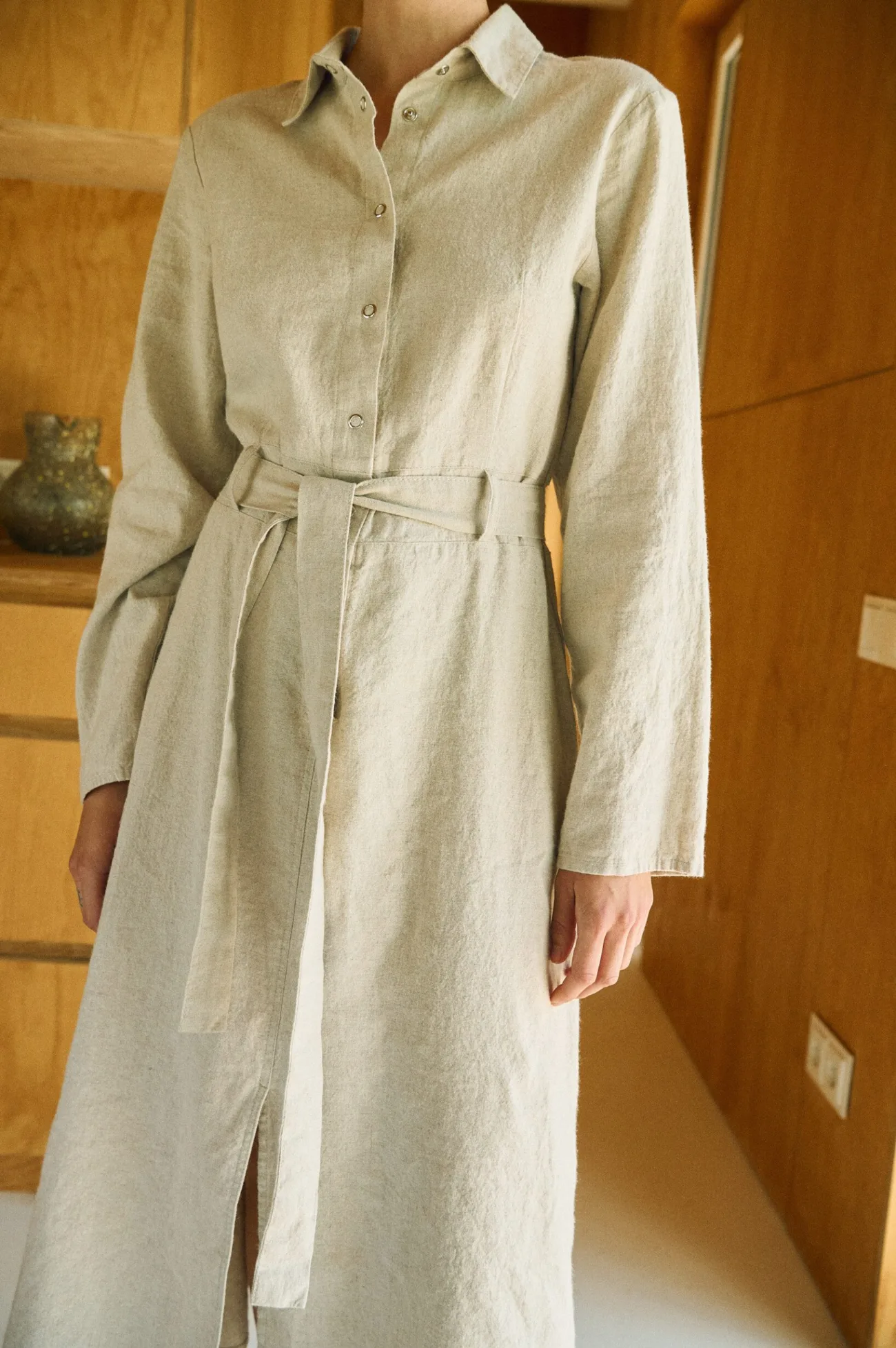 Detail of the shirt collar and snap-button placket on the natural linen cotton blend utility dress