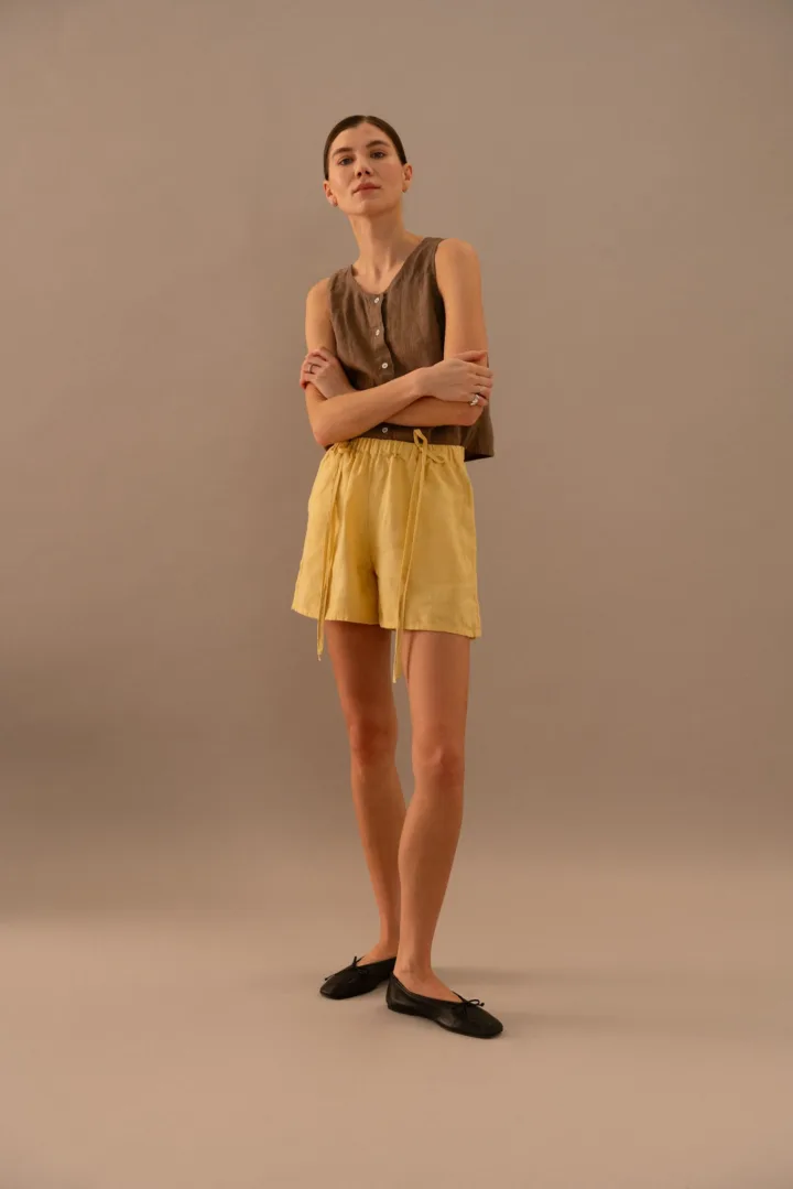 Cacao linen sleeveless top styled with butter linen drawstring shorts in relaxed fit