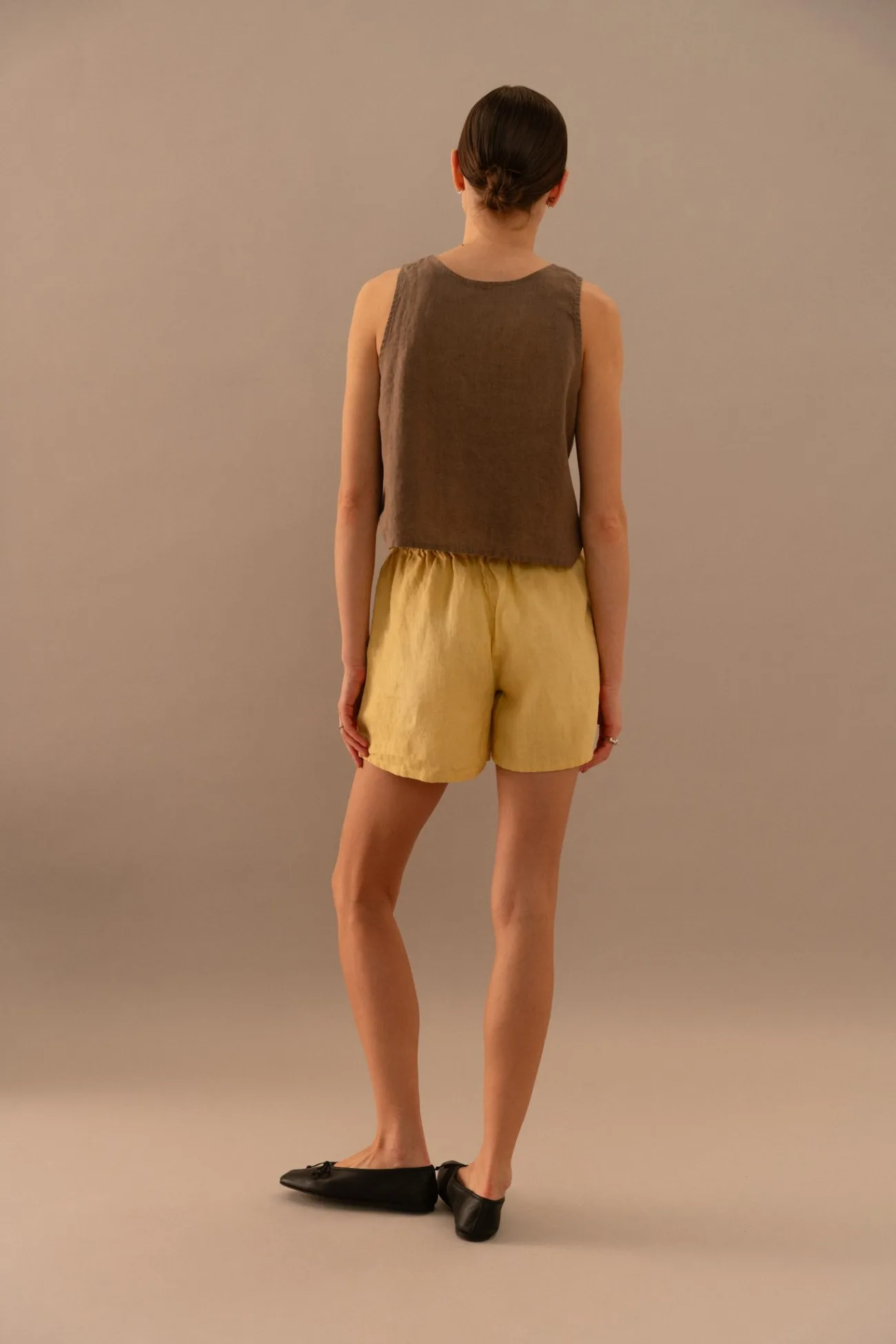 Back view of cacao linen sleeveless top with butter linen elastic waist shorts