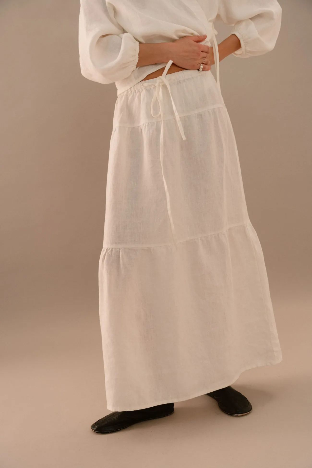 White linen maxi skirt with relaxed A-line shape and lightweight texture