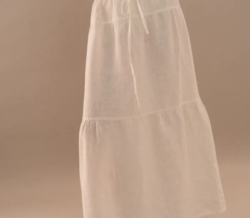 White linen maxi skirt with relaxed A-line shape and lightweight texture