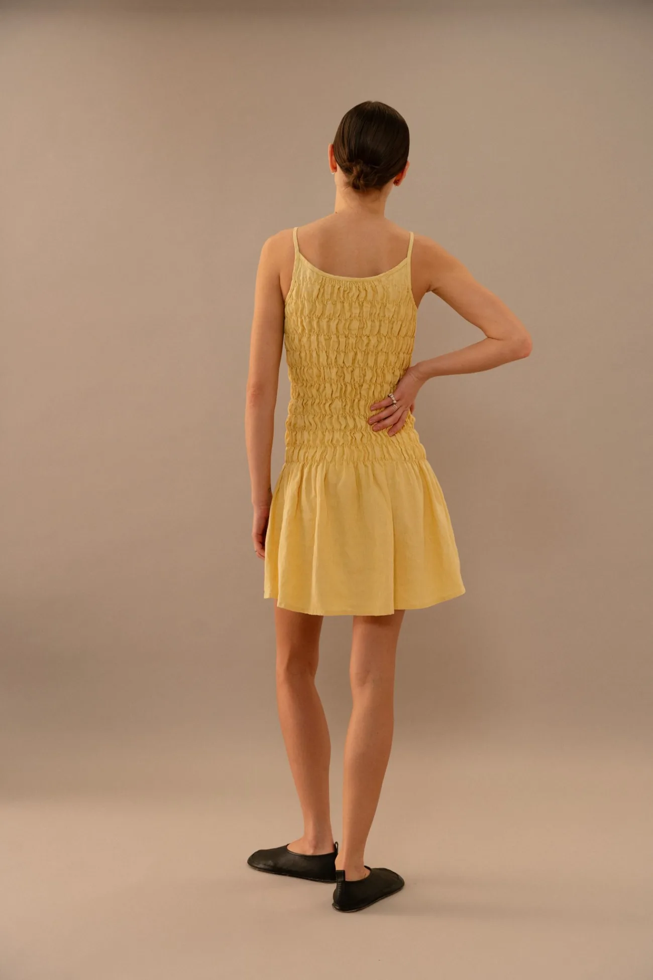 Butter yellow linen mini dress with smocked bodice, back view