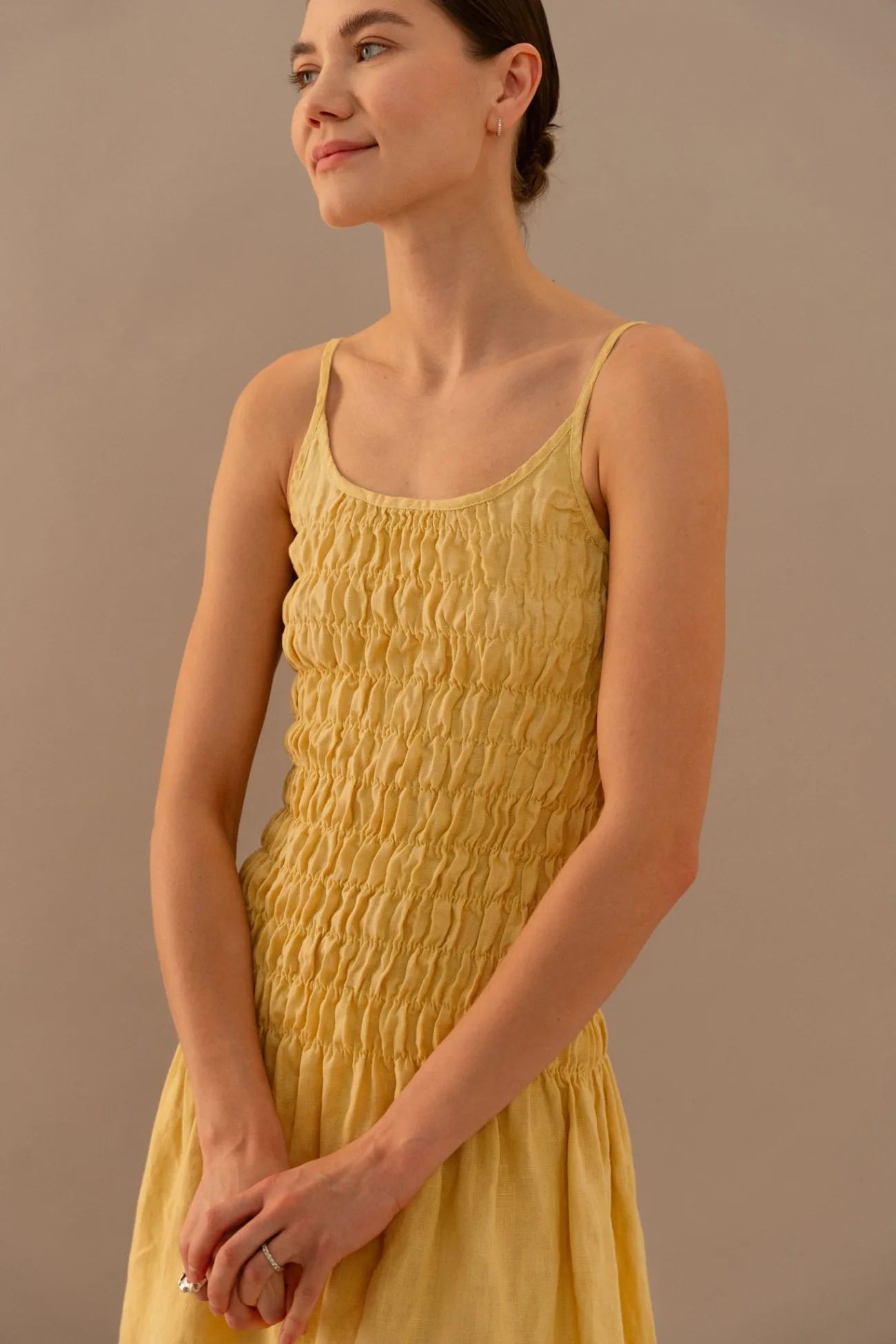 Butter yellow linen mini dress with fitted smocked top and gathered skirt