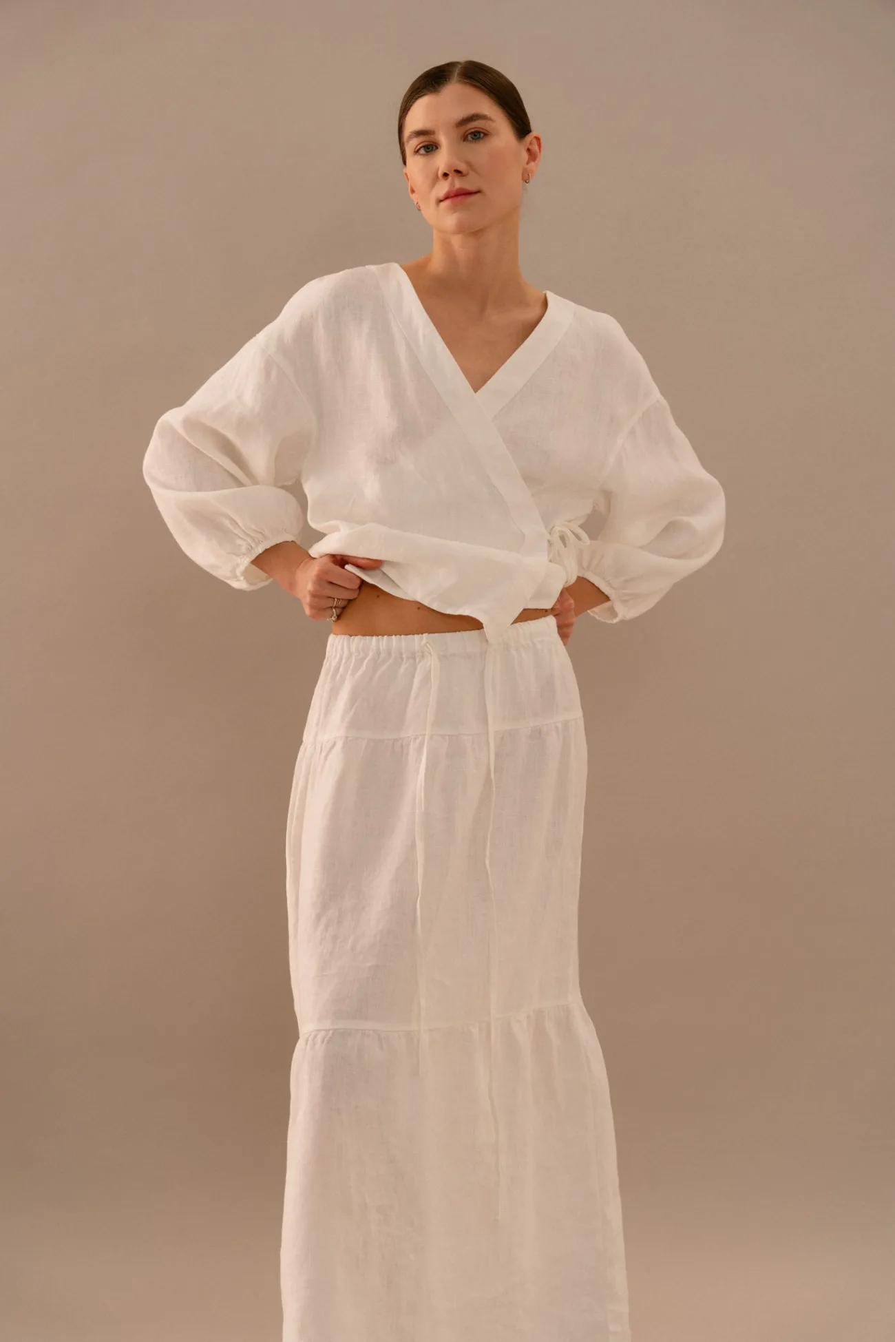 Milky white linen wrap top styled with tiered maxi skirt featuring elastic waistband and drawstring