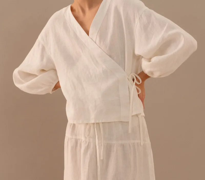 Milky white linen wrap top with side tie and long balloon sleeves paired with tiered maxi skirt