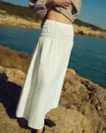 Milky white linen maxi skirt with a wide smocked elastic waistband and relaxed, flowing silhouette
