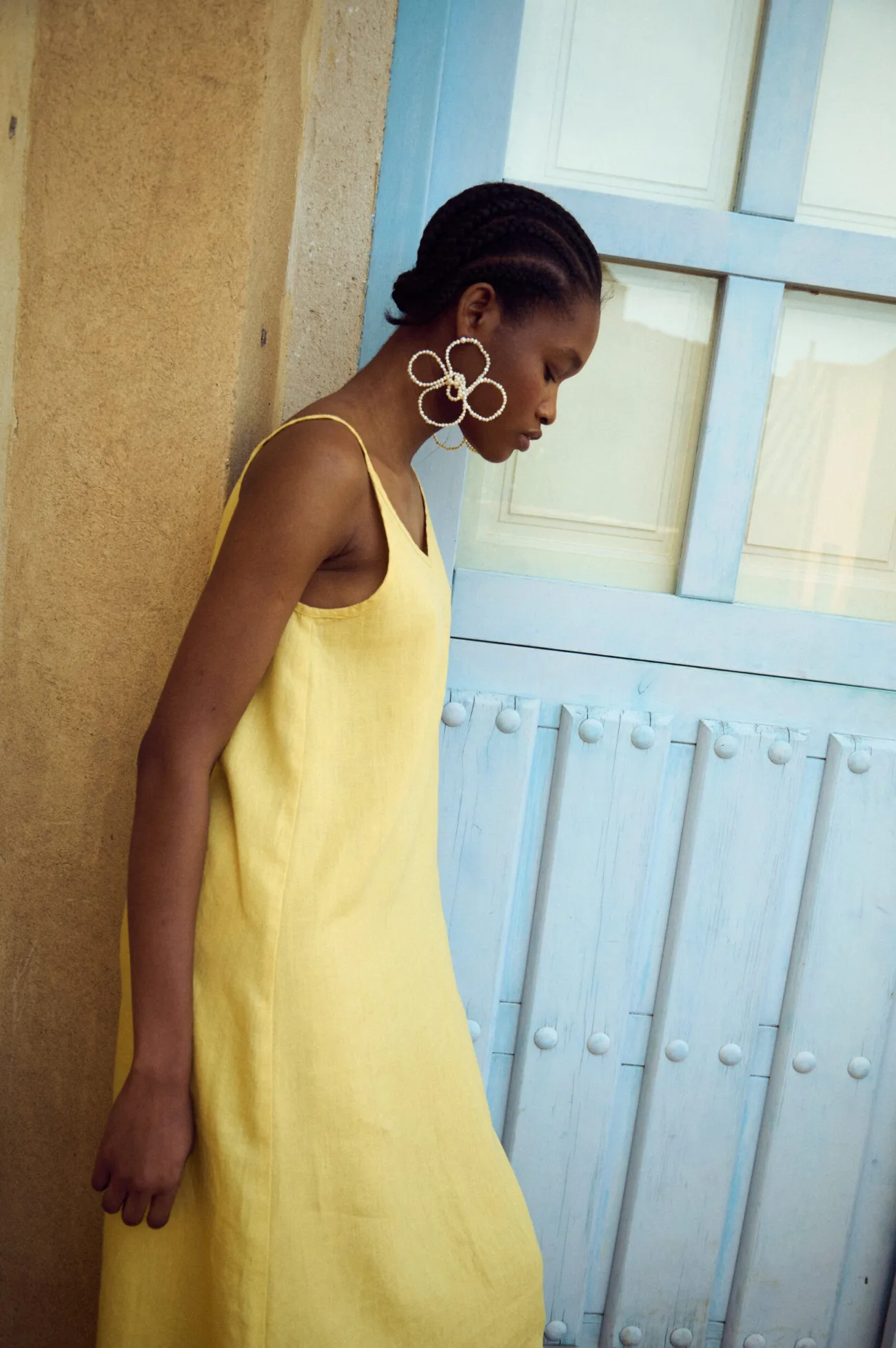 side view of butter linen slip dress with thin straps styled for summer