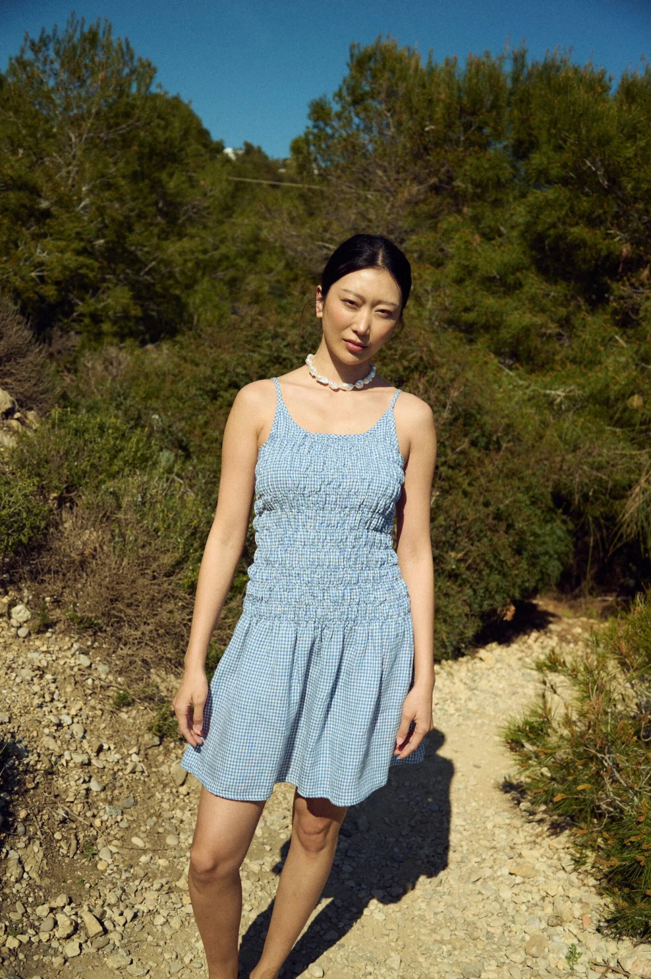 Light blue mini gingham dress with a smocked bodice and soft flared skirt