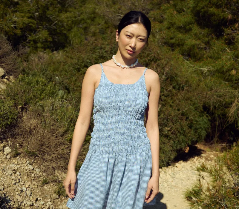 Light blue mini gingham dress with a smocked bodice and soft flared skirt