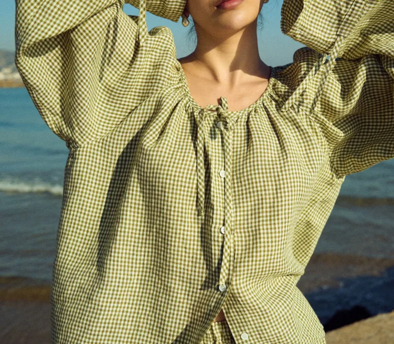 Green mini gingham linen top with gentle gathers at the neckline and wide sleeves, styled with linen shorts