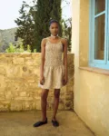 Brown gingham mini dress with textured ruching through the bodice and a loose hem