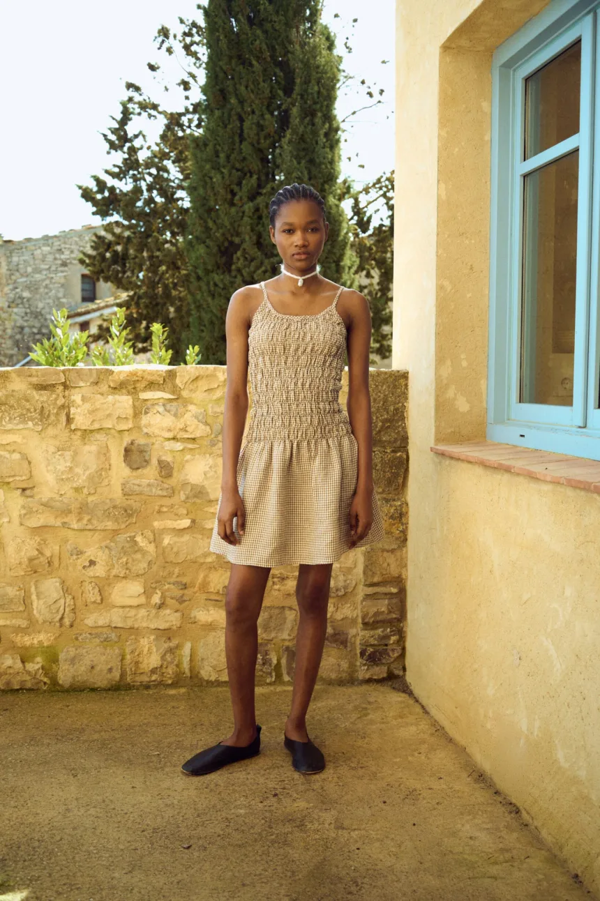 Brown gingham mini dress with textured ruching through the bodice and a loose hem
