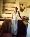 woman wearing white linen tie front top and mini gingham linen skirt