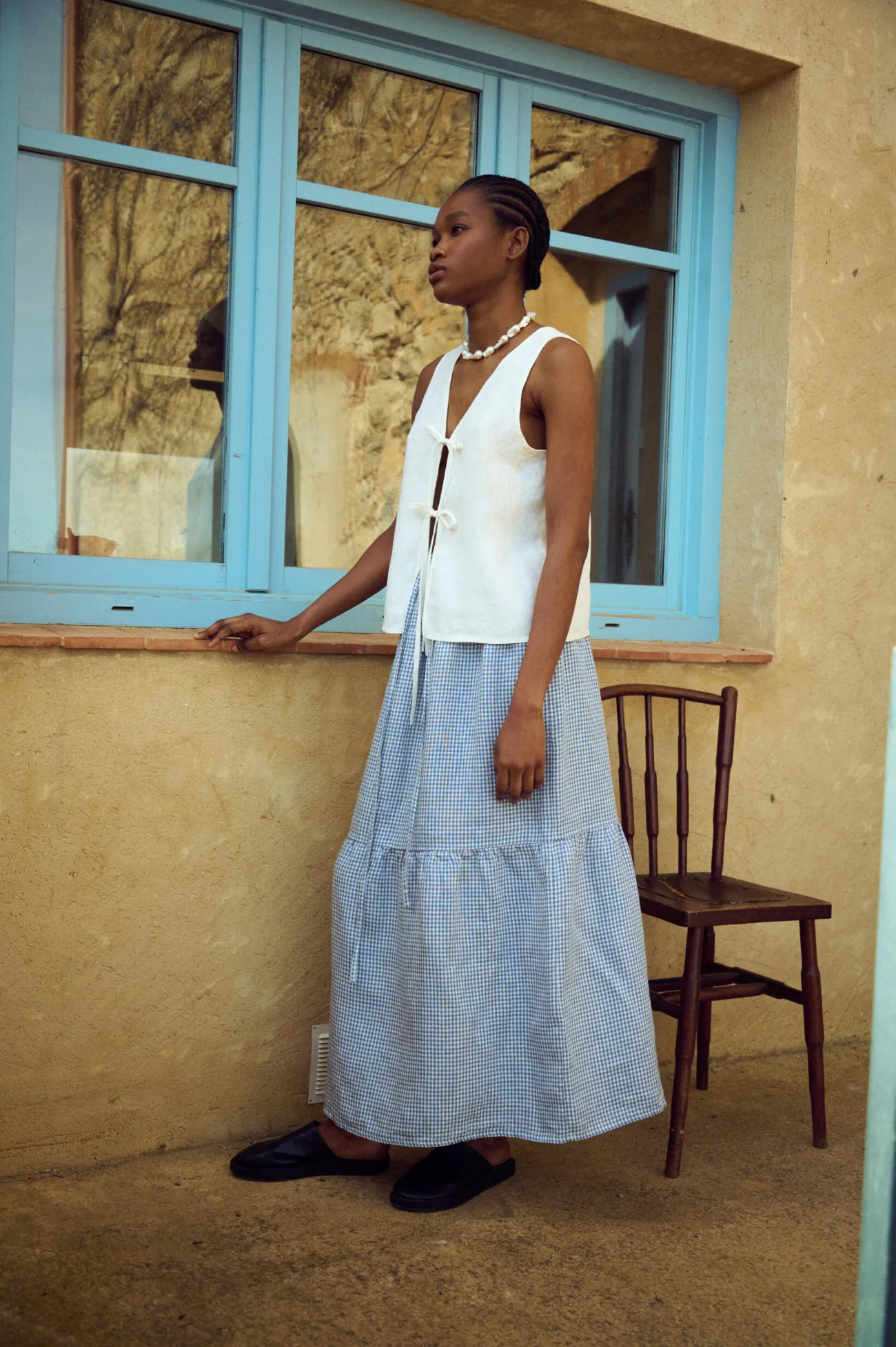 white linen tie front top styled with tiered gingham maxi skirt in full length view