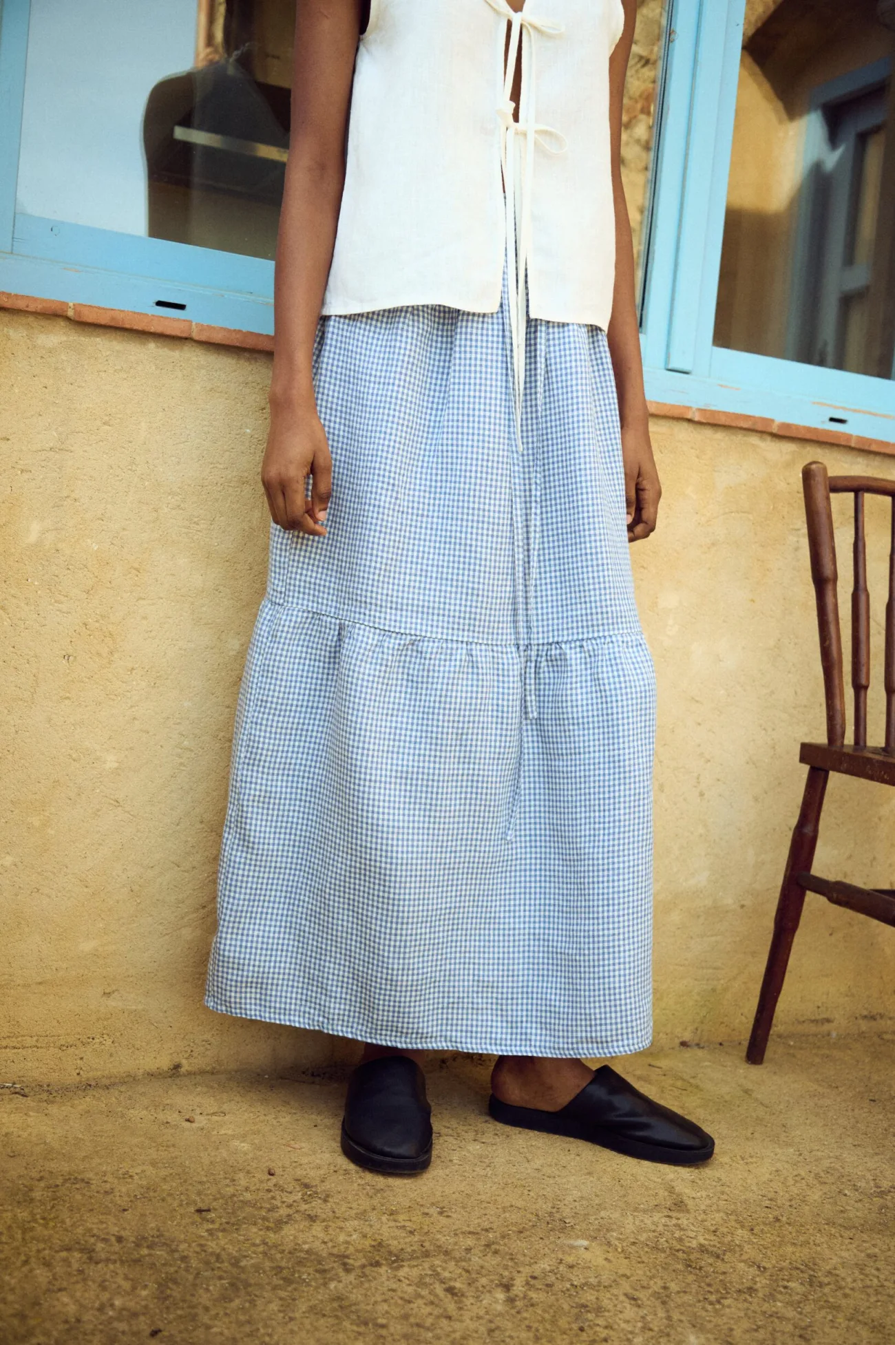 Lightweight blue gingham linen skirt with tiered hem and relaxed, flowing silhouette