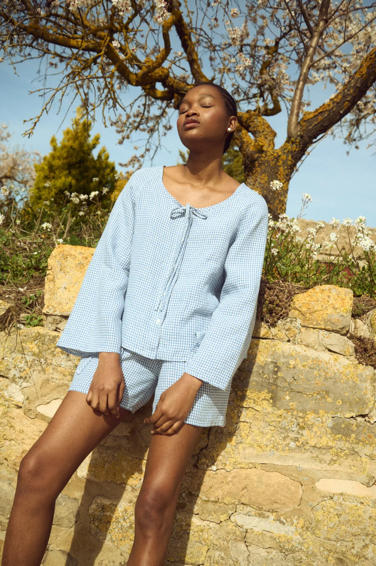 Linen top in blue mini gingham with soft neckline and shell button front, paired with coordinating shorts