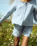 Blue gingham linen top with clean shell button front and relaxed sleeves, paired with coordinating shorts
