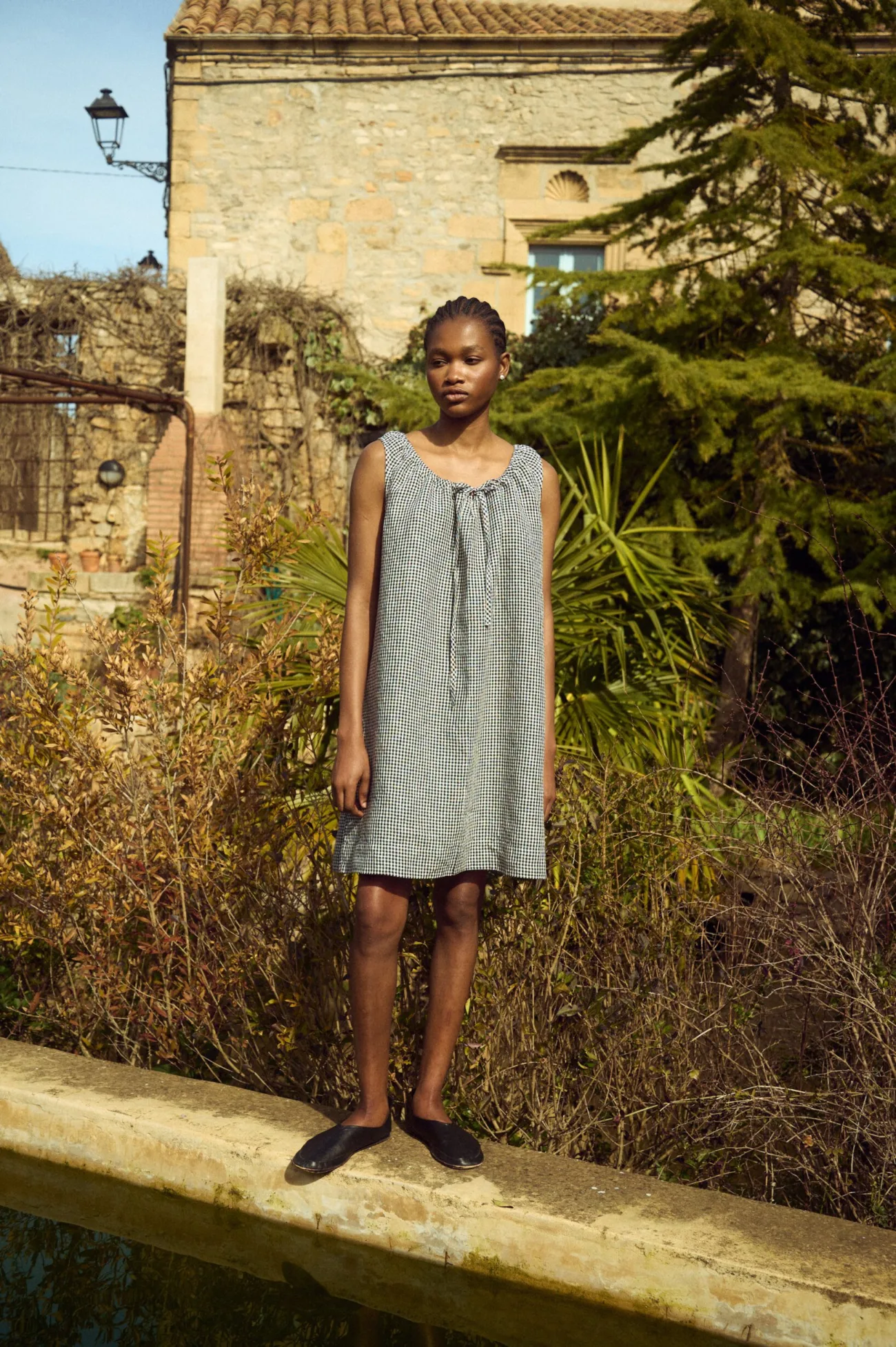 Lightweight black gingham linen dress with adjustable drawstring neckline and loose, flowing shape