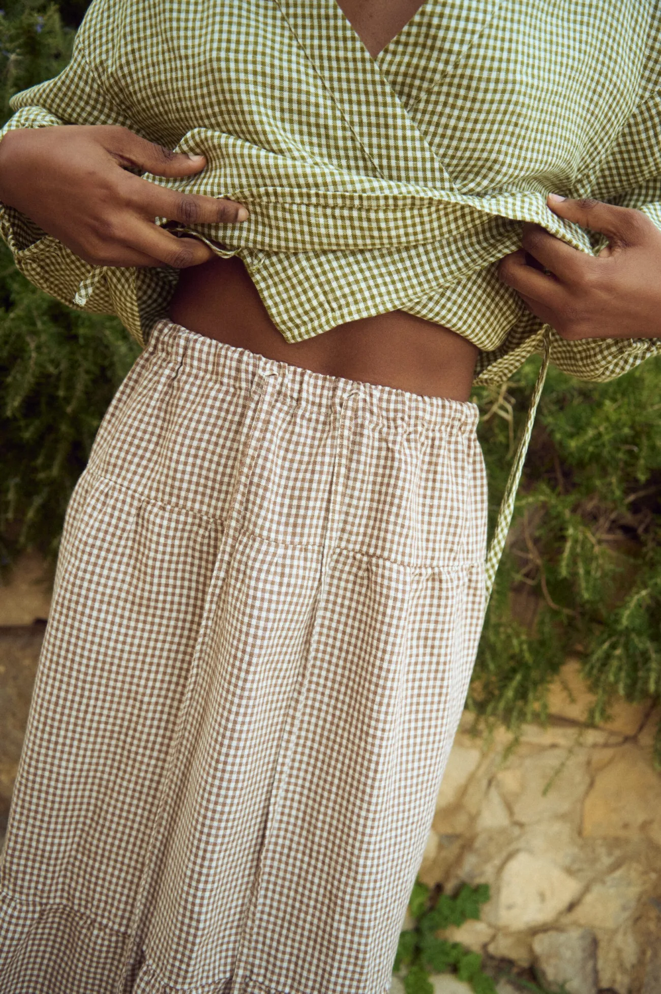 Brown gingham linen skirt with elasticated waistband and gathered tier, shown in close-up detail