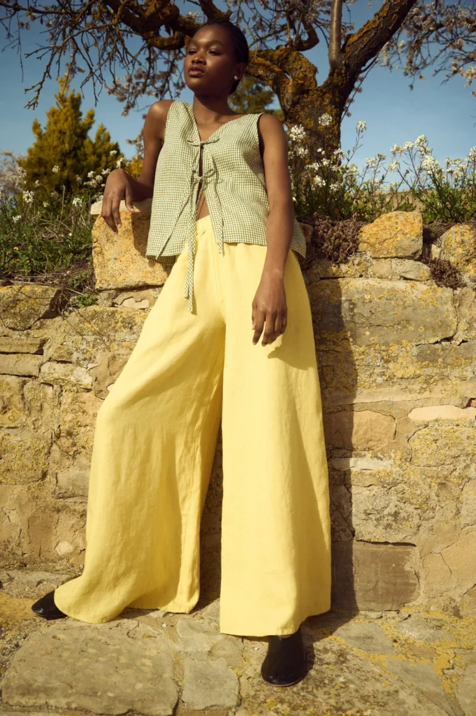 model is wearing butter linen culottes and gingham tie front top