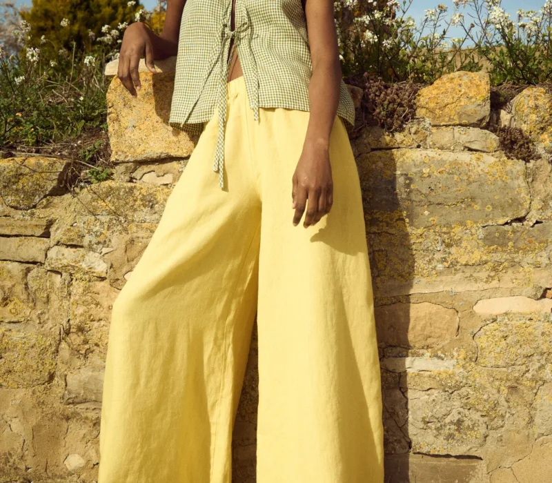 model is wearing butter linen culottes and gingham tie front top