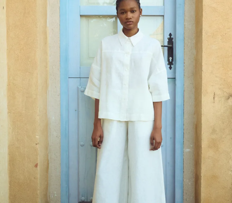 Wide leg white linen culottes worn with matching linen shirt