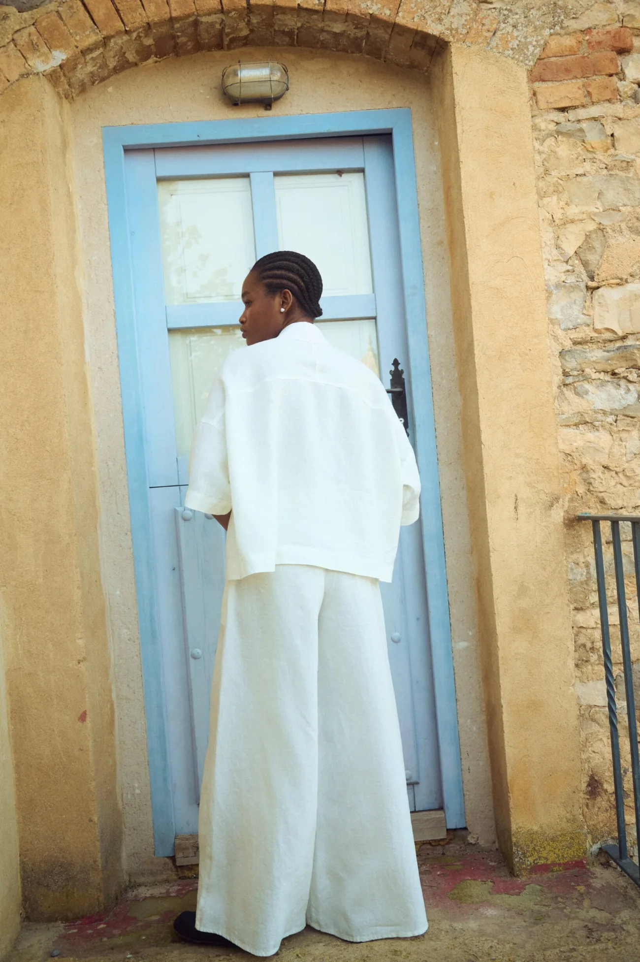 the back of white set of wide leg linen culottes and matching linen shirt