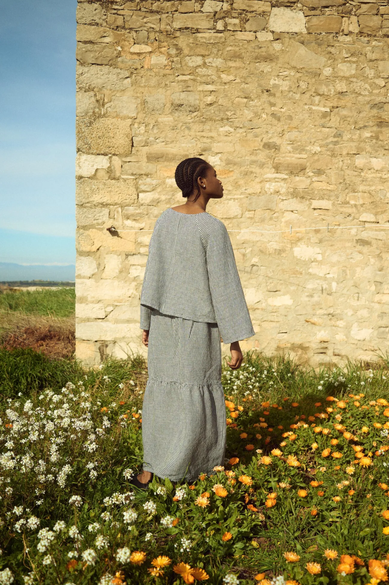Black gingham linen top shown from the back with soft drape and minimal finish